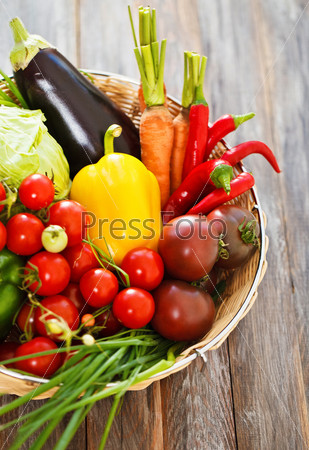 Vegetables still life on wooden background with copy space
