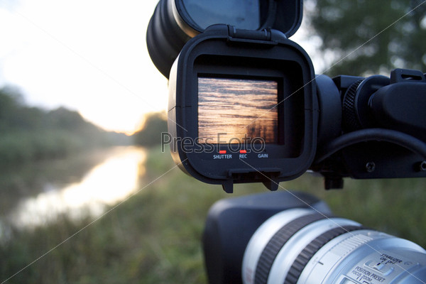 A videocamera filming river, stock photo