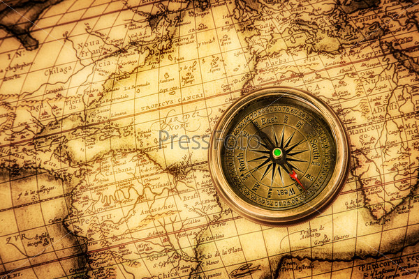 Vintage Still Life. Vintage Compass Lies On An Ancient World Map.