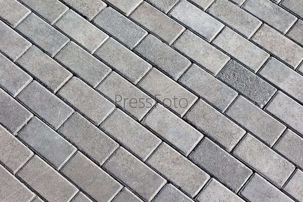 Path background fragment. Path made of small grey bricks.