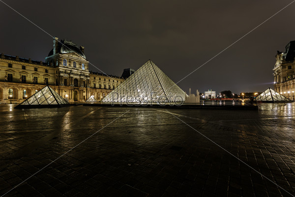 PARIS - NOV 09 : View of the Louvre Pyramid and Pavillon Richelieu in the evening, Nov 09, 2012, Paris, France. The pyramid serves as the main entrance to the Louvre Museum
