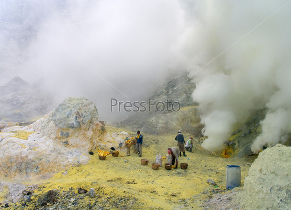KAWAH IJEN,INDONESIA-JAN 10:Unidentified miners harvest raw sulphur from the crater of Kawah Ijen volcano in hazardous working environment with minimal protection on Jan10,2011 in Kawah Ijen