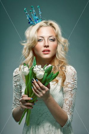blonde girl wearing princess crown holding white tulips