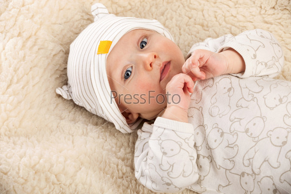 Closeup portrait of baby boyis a sheep-blanket