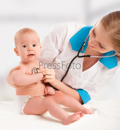 Baby and doctor pediatrician. doctor listens to the heart with s