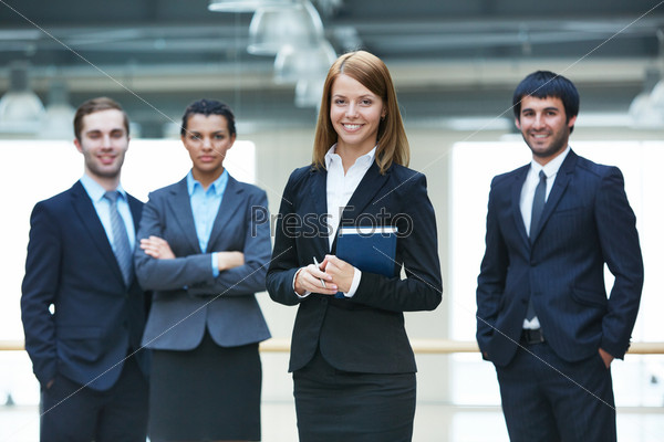 Group Of Smart Businesspeople With Happy Female Leader In Front