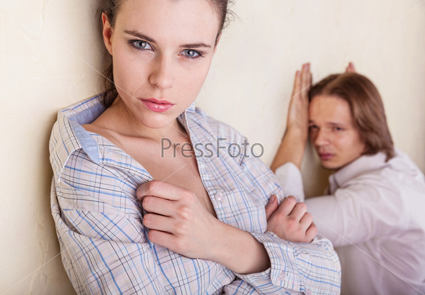 Couple in deep thought after a quarrel. The girl in the foreground