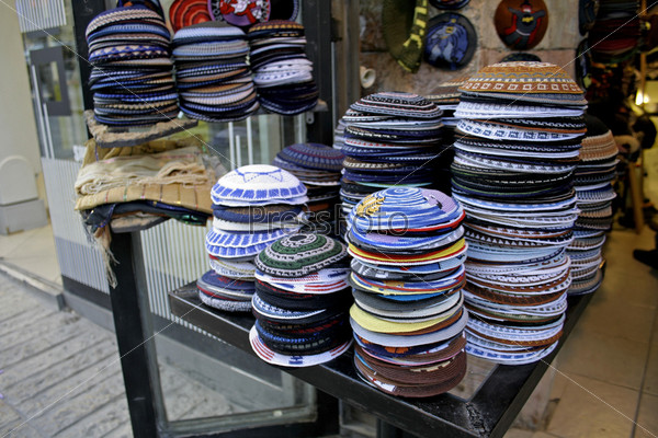 pile of kippas on display in store front, jerusalem