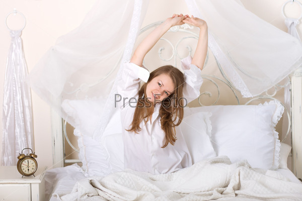girl stretching on a bed