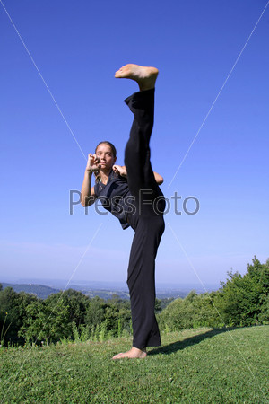 kick - attractive young woman practicing self defense