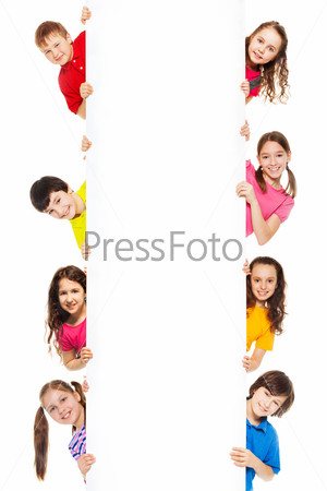 Six kids looking from blank billboard