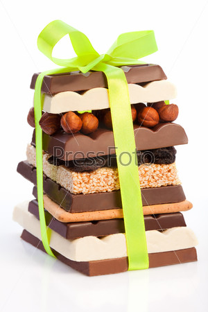 Pyramid of sweets, chocolate, nuts, cookies decorated with ribbon as a present