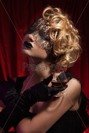 Lonely beauty  - beauty portrait of a woman with curly and blond hair and vial bandage on face with professional make up and hair style