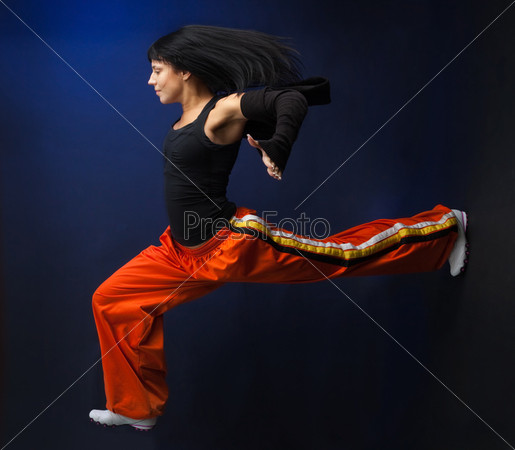 Woman running fast to be in time, on dark background