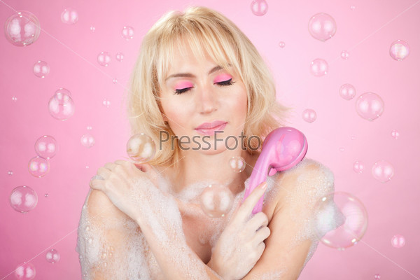 Beautiful happy young girl having a relaxation bath