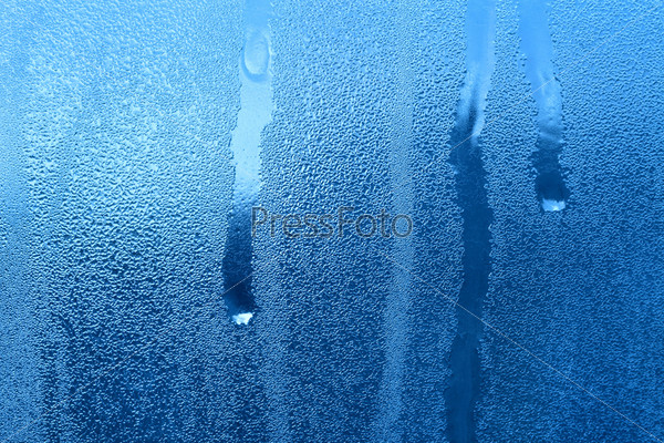 Frozen water drops on window glass