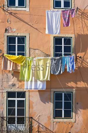 Laundry - Washed clothes hanging outside an old building of Lisbon, Portugal