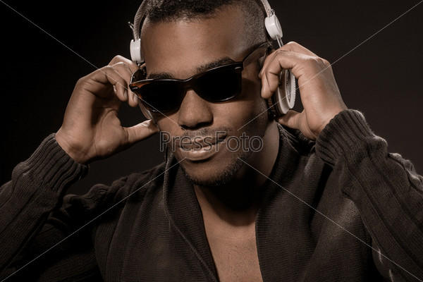 photo of afro american guy listen to music with headphones