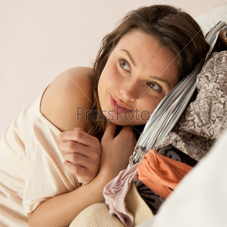Portrait of young woman preparing for big trip and vacation she can not wait and have a big fun with packing her props and clothes