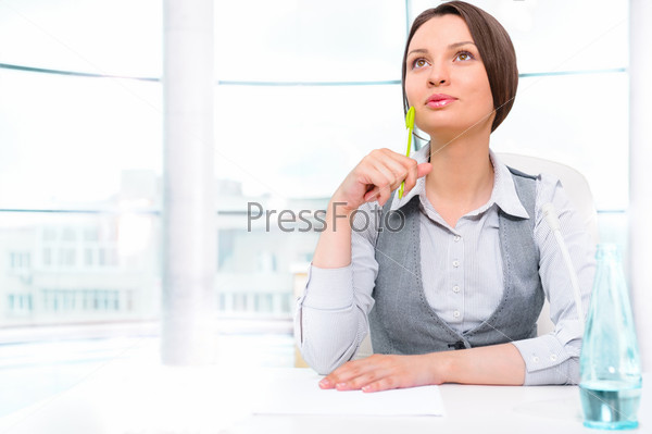 Portrait of happy young business woman thinking about something