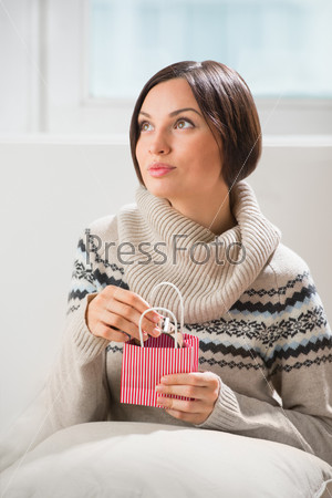 Portrait of a woman preparing to her husband or boyfriend\
surprise with a gift - modern watch with timepiece on his birthday\
or valentine\'s day or another holiday