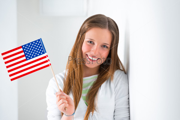 Portrait of a lovely young woman with United State\'s flag smiling