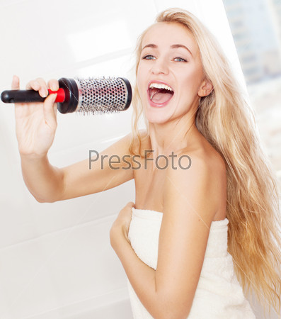 Woman in the morning at bathroom. Funny female sing song in comb
