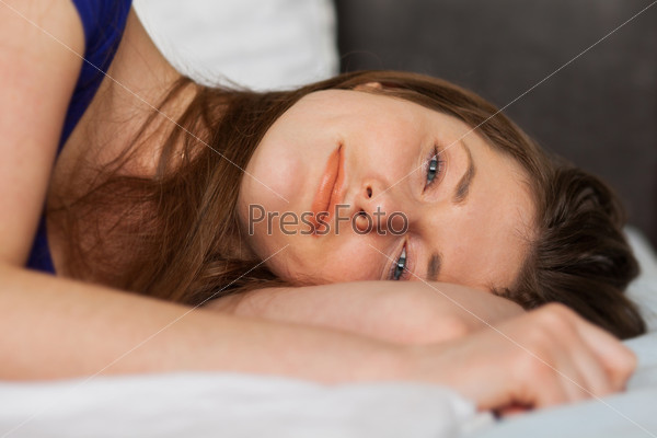 Beautiful caucasian girl lying in the bed relaxed