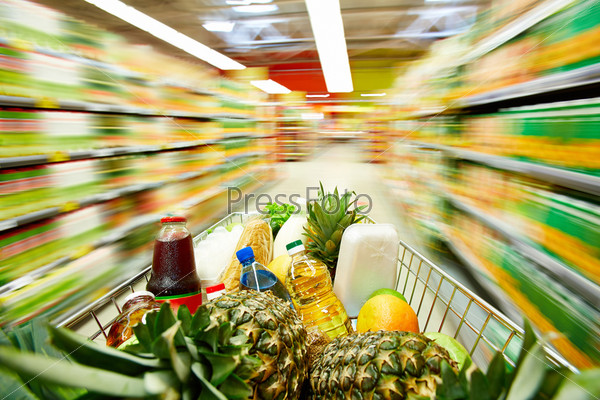 Image of cart full of products in supermarket