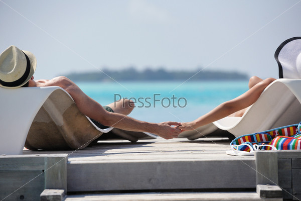 Happy young romantic couple in love have fun running and relaxing on beautiful beach, stock photo