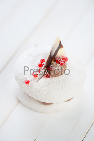Vertical shot of a fancy cake on wooden boards