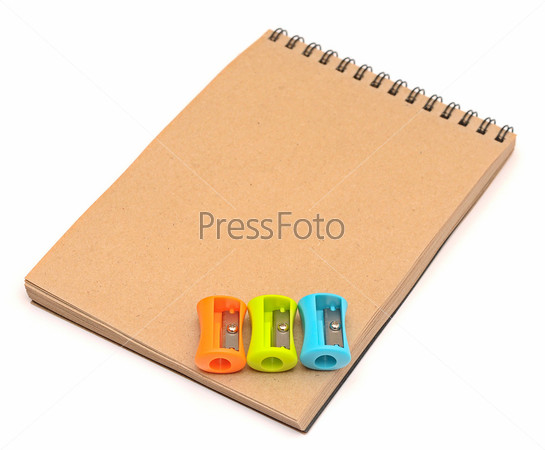 Colorful sharpeners on recycle notebook on white background. , stock photo