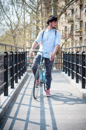 hipster young man on bike in the city