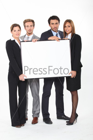 Four young executives holding a framed board left blank for your image