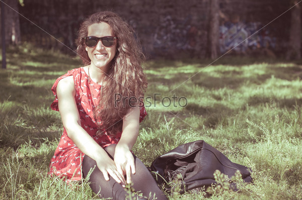 Eastern hipster vintage woman with shades at the park