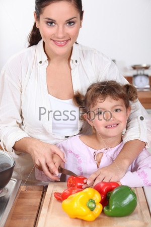 Mother and daughter cooking together.