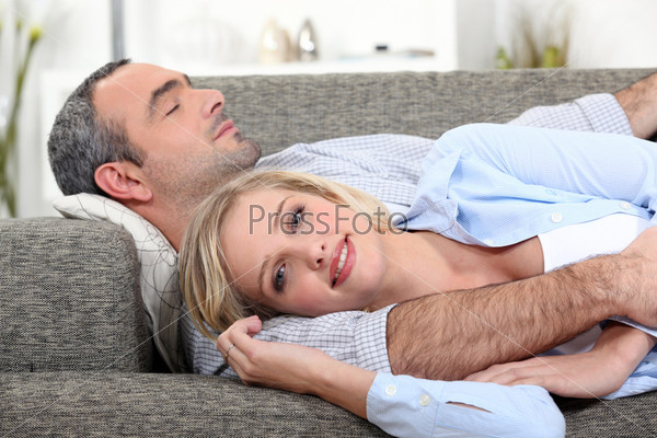 Couple lying on the couch, stock photo