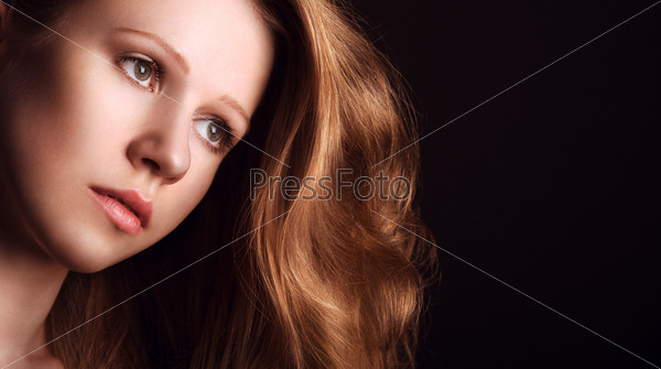 sad, melancholy, enigmatic, mysterious girl with long red hair on a dark background