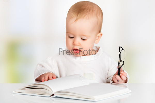 Funny baby reading a book