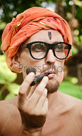 Portrait of a man smoking pipe in glasses