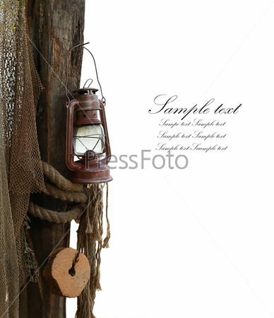 composition is marine consisting of an old lamp, rope and fishing net isolated in white