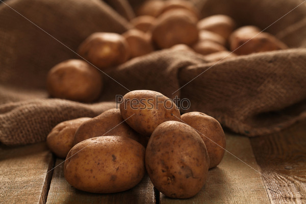 Rustic unpeeled potatoes on a desks