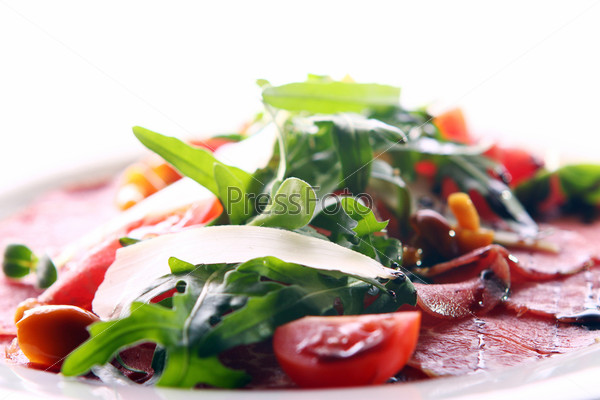 Beef carpaccio served with ruccola and mushroom
