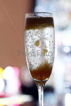 Closeup image of cocktail in a champagne glass at the bar