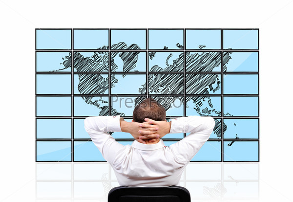 man looking on  flat panels with world map