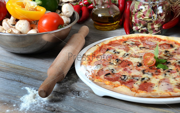 The Italian pizza with ham and mushrooms