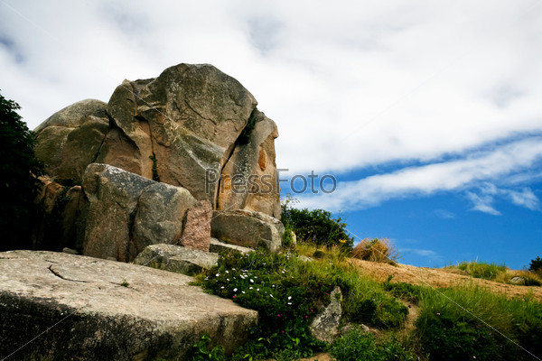 granite block under blue sky and white cloud in Brittany, France