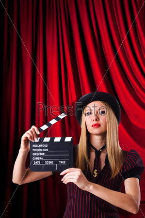 Woman gangster with movie clapper, stock photo