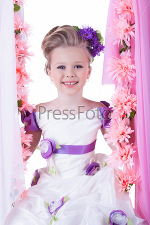 Beautiful little girl near pink flowers