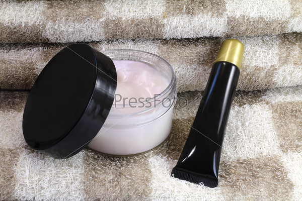 Cream for the skin of the body and facial massage and a towel to massage the body after a bath